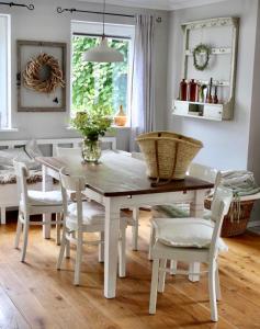 a dining room with a white table and chairs at Haus Strandleben in Hohwacht