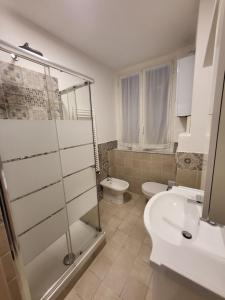 a bathroom with a shower and a toilet and a sink at Puppo Apartments in Corniglia +31 photos