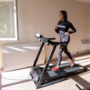 a woman running on a treadmill at Village Vacances Cap France La Bolle in Saint Die