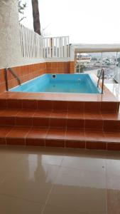 a jacuzzi tub in a house with brown steps at The Mountain Terrace in Masāfī