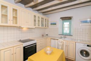 A kitchen or kitchenette at Galatea House Katoï with patio