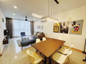 a dining room and living room with a table and chairs at [PROMO]Connected train 2 Bedroom (ABOVE MALL)15 in Kuala Lumpur