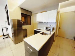 a kitchen with a sink and a refrigerator at [PROMO]Connected train 2 Bedroom (ABOVE MALL)15 in Kuala Lumpur