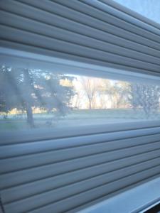 a close up of a window with a blind at Oaza apartmani 1 in Senta