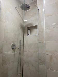 a shower stall with a glass door in a bathroom at Prenoćište Stari Grad - Old Town in Tuzla