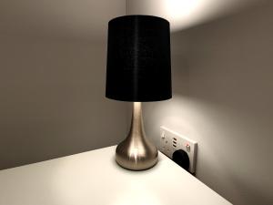 eine Lampe, die auf einem Tresen neben einer Steckdose sitzt in der Unterkunft Private Room in Exclusive Apartment in Aberdeen