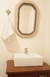 a bathroom with a sink and a mirror on the wall at Departamento Benissa en San Juan in San Juan