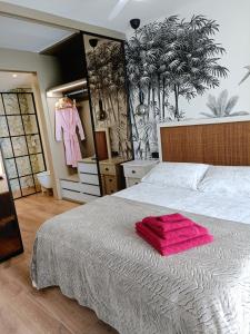 ein Schlafzimmer mit einem Bett und einem rosa Handtuch darauf in der Unterkunft Portofino Flying Whale in Benidorm