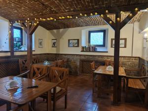 a dining room with wooden tables and chairs at Willa Janina in Lądek-Zdrój