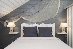 a bedroom with a hammock hanging above a bed at Les Gîtes De Noreda in Gujan-Mestras