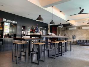 a restaurant with tables and a christmas tree on the wall at DUM Hotel - Si Phum in Chiang Mai