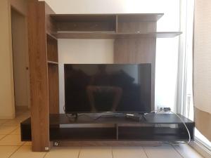 a large flat screen tv sitting in a entertainment center at Depto con internet y tv cable in Ovalle