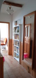 a room with a book shelf and a door at Chalupa Kojetice in Kojetice