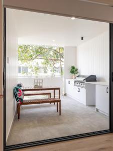 a kitchen with a bench and a table at Unique Kirra townhouse in Gold Coast