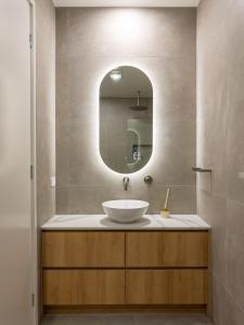 a bathroom with a sink and a mirror at Unique Kirra townhouse in Gold Coast