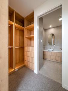 a bathroom with wooden cabinets and a sink at Unique Kirra townhouse in Gold Coast