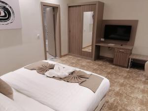 Uma cama ou camas num quarto em Gloria Hotel & Suites Doha