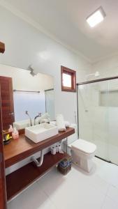 a bathroom with a sink and a toilet and a shower at POUSADA RANCHO PARAISO in Pôrto de Pedras