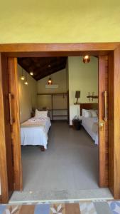 a large room with two beds and a room with at POUSADA RANCHO PARAISO in Pôrto de Pedras