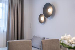 a living room with a couch and two lights on the wall at Miramonte in Sölden