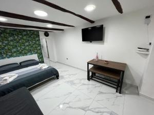 a bedroom with a bed and a television on a wall at NUVISA in Naples