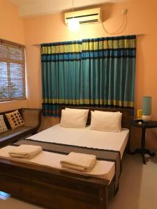 a bedroom with a large bed and a window at Araliya Suite in Nugegoda