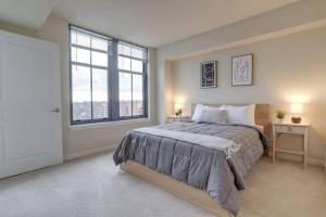 a bedroom with a large bed and a large window at Fantastic 2 BR Condo At Pentagon City With Gym in Arlington