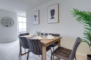 a dining room with a wooden table and chairs at Fantastic 2 BR Condo At Pentagon City With Gym in Arlington