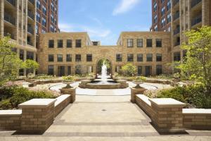 a courtyard with a fountain in front of a building at Fantastic 2 BR Condo At Pentagon City With Gym in Arlington