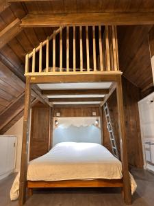 a wooden bunk bed in a room with a ladder at Grange de Trabés n°2 in Gèdre