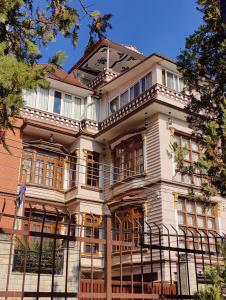 una grande casa con una recinzione davanti di Sherpa Home Hotel a Kathmandu