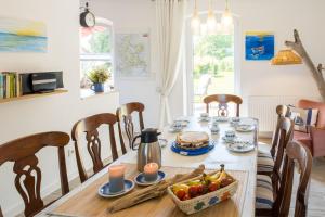 a dining room with a table with food on it at Familienhaus Sonne in Mukran