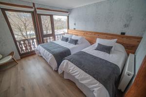 Cama o camas de una habitación en Hotel Vivo Montaña