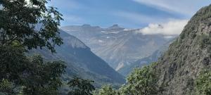 a view of a mountain range with clouds in the sky at Grange de Trabés n°2 in Gèdre +7 photos
