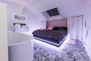 a bedroom with a bed and a tub in it at Lasuite55 in Istres