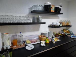 a kitchen counter with food and drinks on it at Zum Kronprinzen Hotel Garni in Weyher