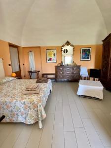 a bedroom with two beds and a dresser and a mirror at Cascina la Barona in Savigliano