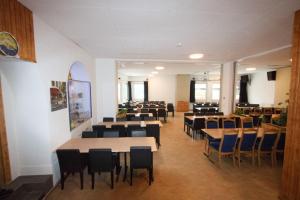 a dining room with tables and chairs in a building at juhui Arosa in Arosa