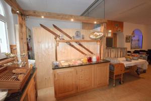 a kitchen with a counter and a table in a room at juhui Arosa in Arosa