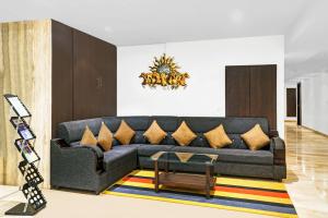 a living room with a couch and a coffee table at Treebo Trend Madhuvan Grand in Vijayawāda