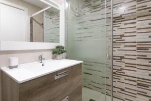 a bathroom with a sink and a shower at Salamanca 10 Relax Time in Santa Pola +16 photos