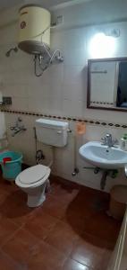a bathroom with a toilet and a sink at Brookefield Service Apartment in Bangalore