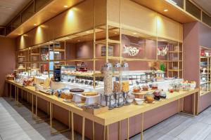 a bakery with a buffet of food on a counter at INNSiDE by Meliá Milano Torre GalFa in Milan