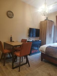 a room with a table and chairs and a bed at Golden Mountain A75 NLux Milmari in Kopaonik