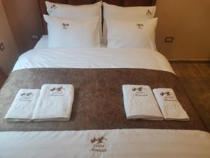 a hotel room with a bed with towels on it at Golden Mountain A75 NLux Milmari in Kopaonik