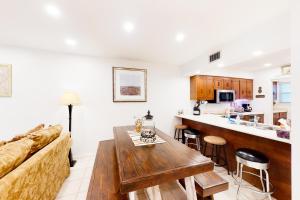 a living room with a couch and a table at Sand Drift Treasure Island in Panama City Beach