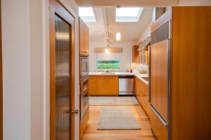 a kitchen with a refrigerator and a sink at Dream Scape in Fort Bragg