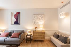 a living room with a couch and a table at FLH Praça Rossio Contemporary Flat in Lisbon