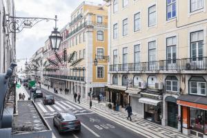a city street with buildings and cars on the road at FLH Downtown Marble Apartment in Lisbon