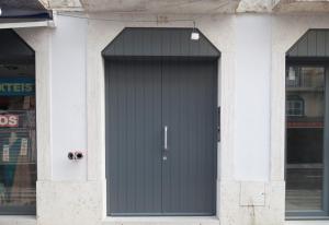 a black door on the side of a building at FLH Downtown Marble Apartment in Lisbon